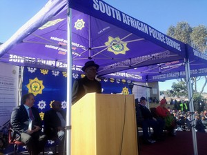 Photo of a man in a hat making a speech