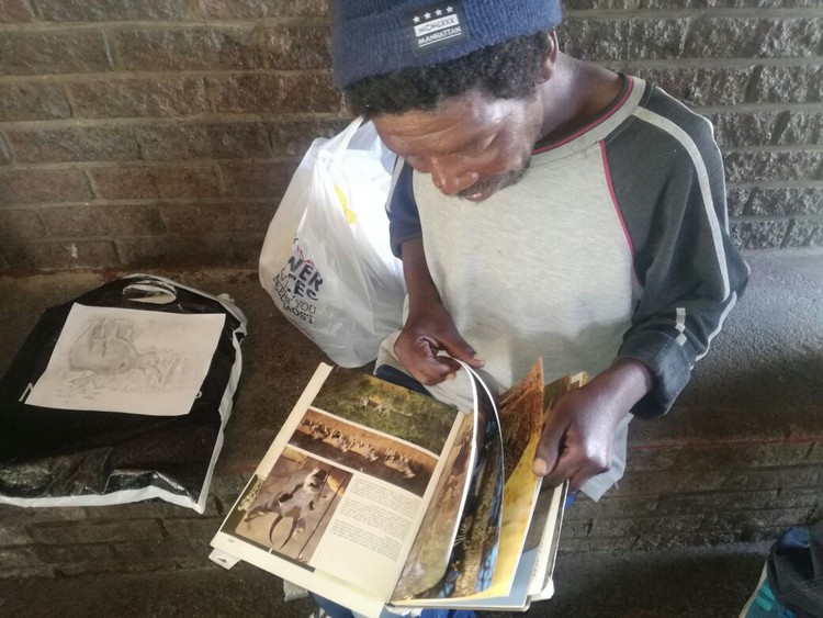 Photo of man looking at book