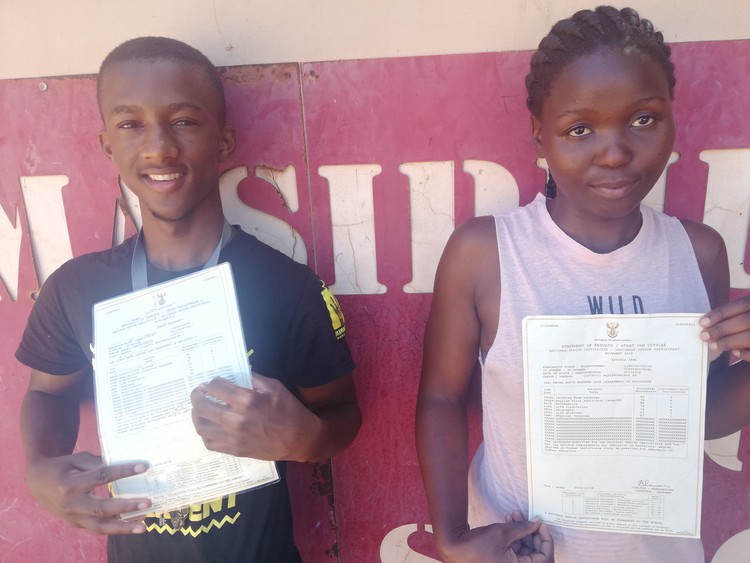 Photo of high school student holding matric certificate