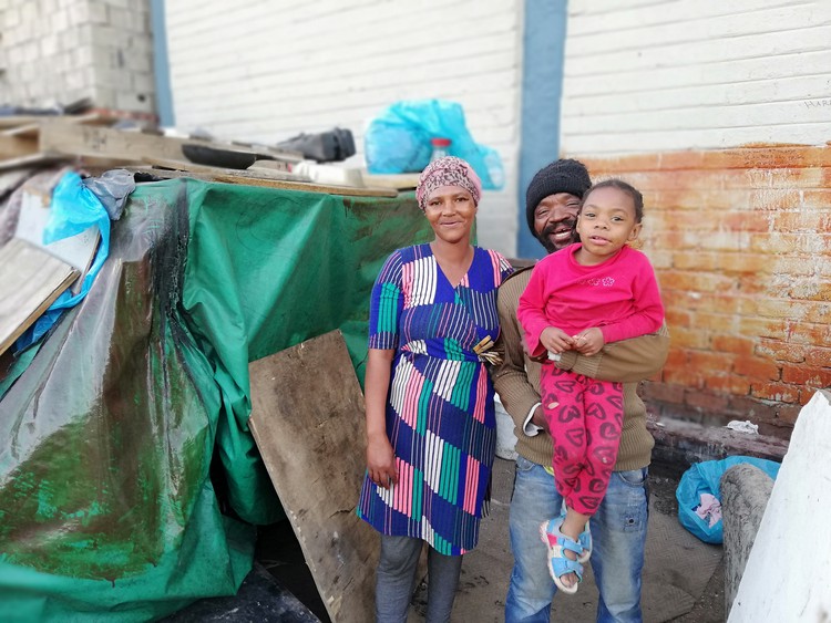 Photo of family in front of shelter