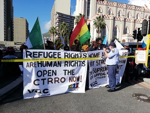 Photo of protestors holding up banners