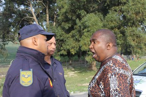 Photo of man shouting at police