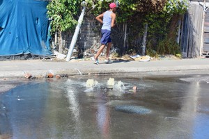 Photo of a street with an overflowing drain