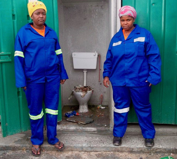 Photo of two women and a dirty toilet