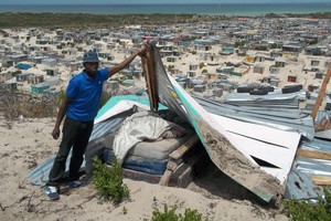 Photo of man showing bed with occupation in background