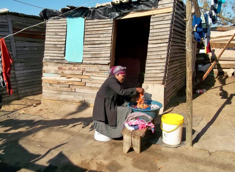 Photo of a woman and a shack