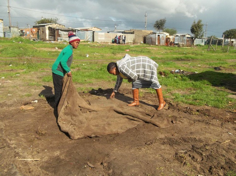 Photo of woman and child picking up a mat