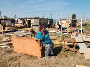 Photo of a woman sitting on a couch on open land