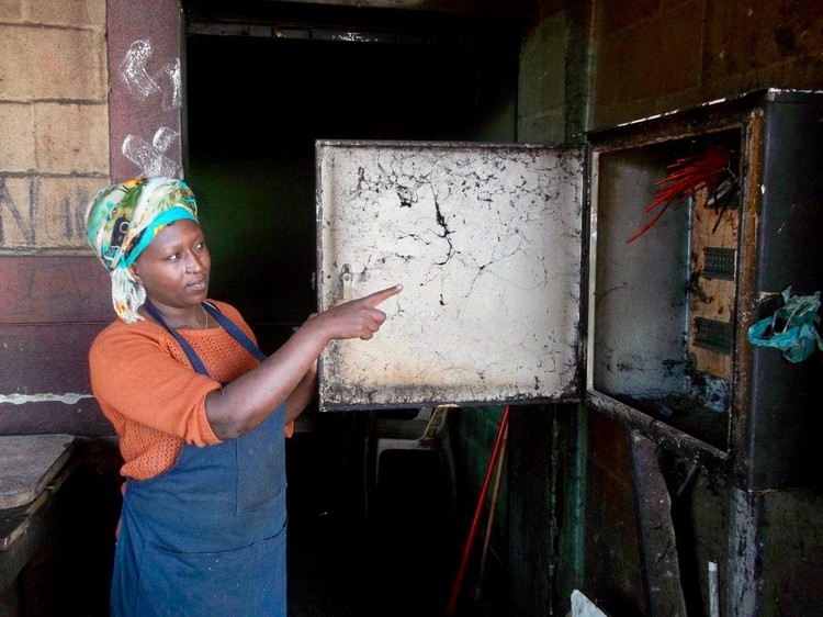 Photo of a woman pointing to an empty electricity box