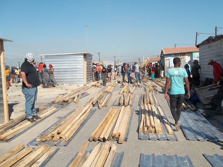 Photo of a person and shack building materials