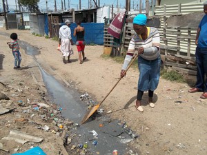 Photo of woman raking stagnant water