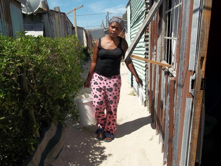 Photo of woman carrying bucket