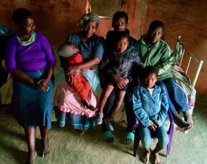 Photo of a family sitting on a bed