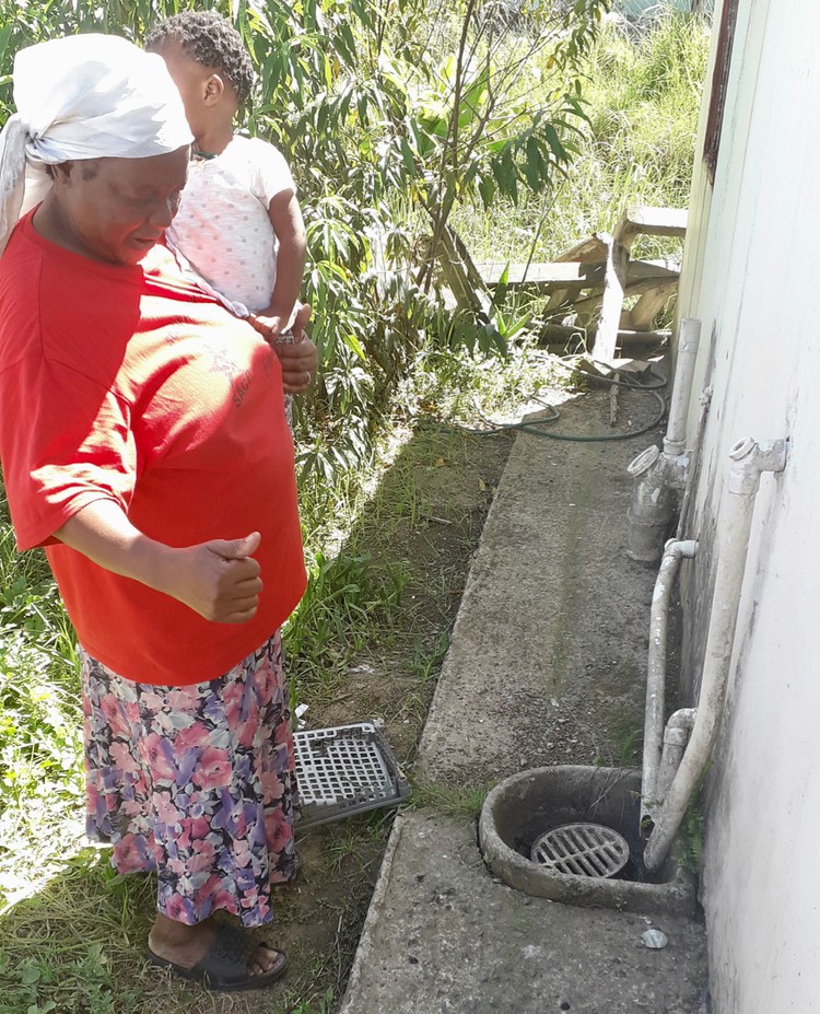 Photo of a woman outside her house