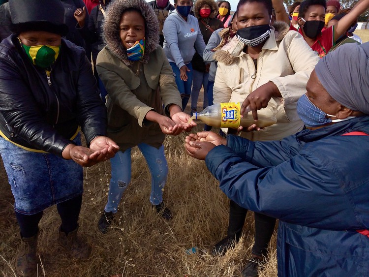 Photo of a group of people pouring water over their hands