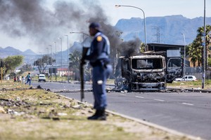 Photo of police and burning vehicle