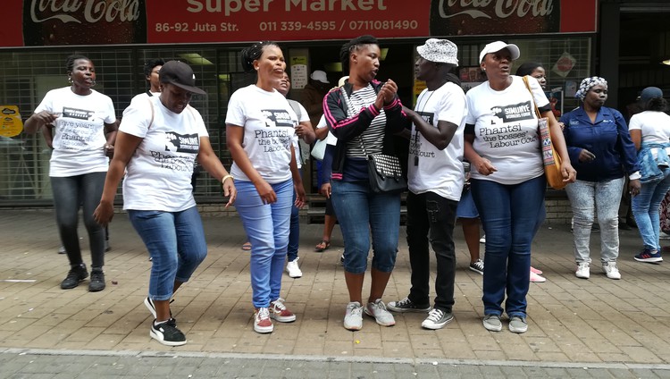 Photo of workers demonstrating outside court