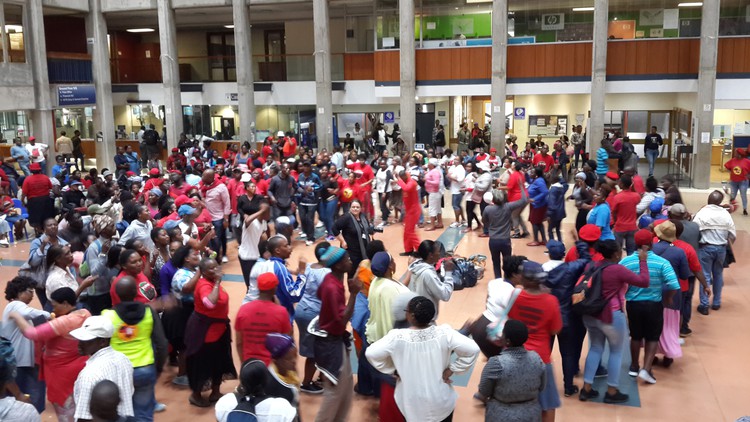 Photo of crowd of workers in hall