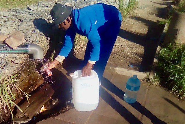 Photo of a man collecting water