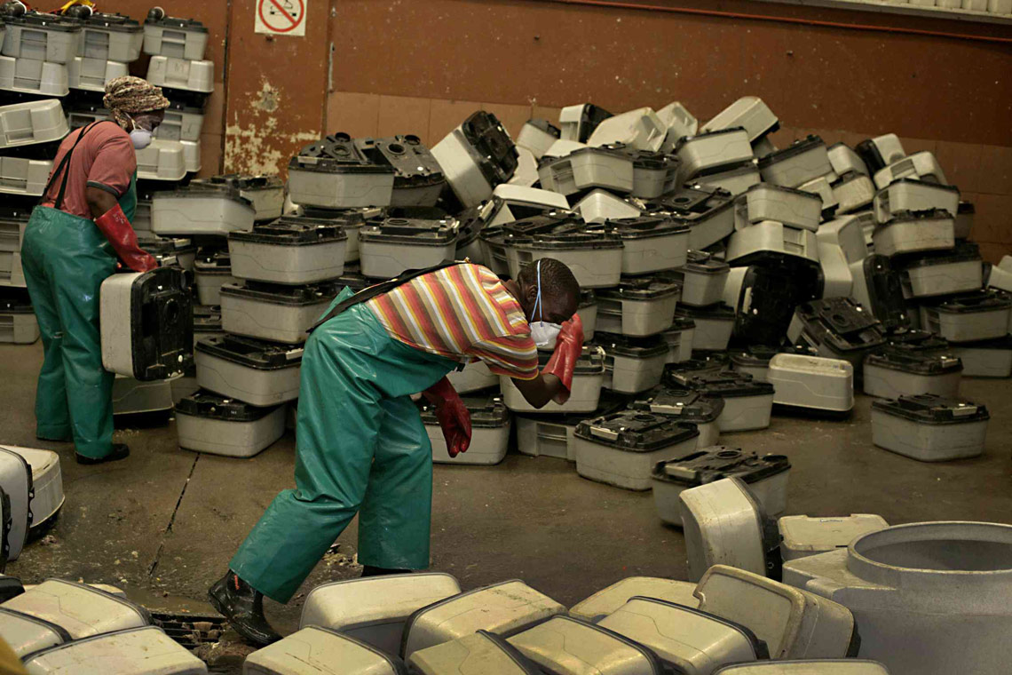 Workers cleaning portable toilets at the Airport Industria depot.​