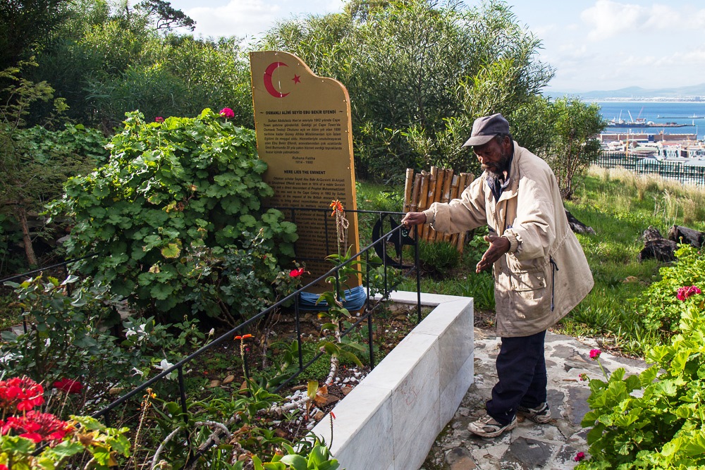 Photo of a man and a grave