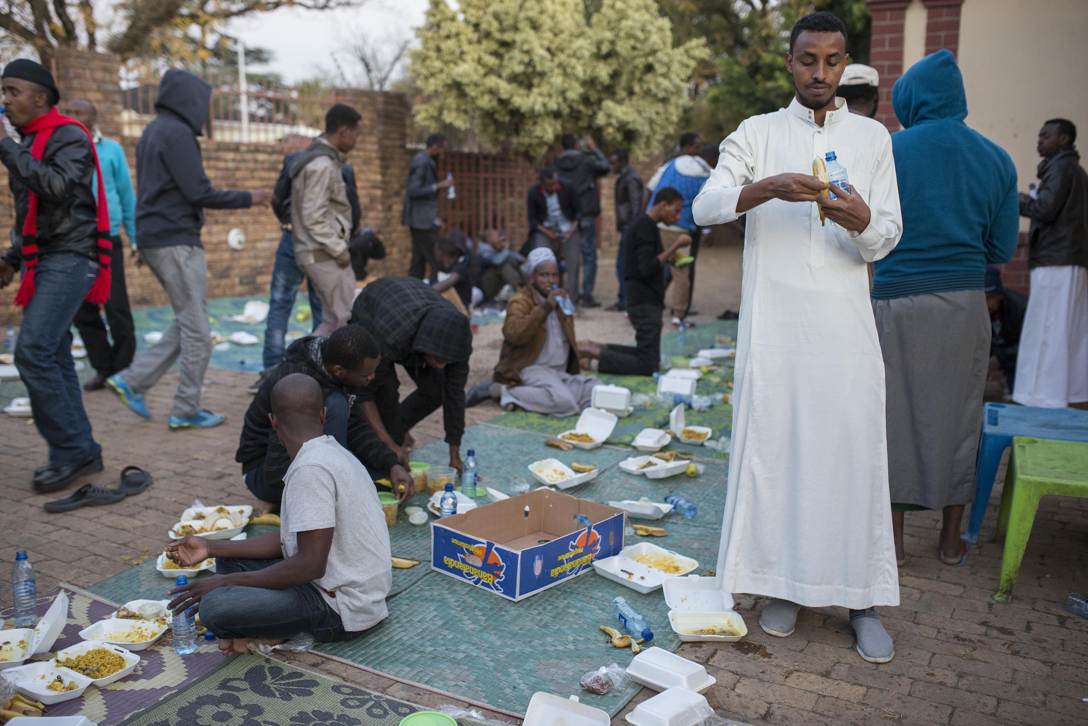 Photo of people eating on the pavement