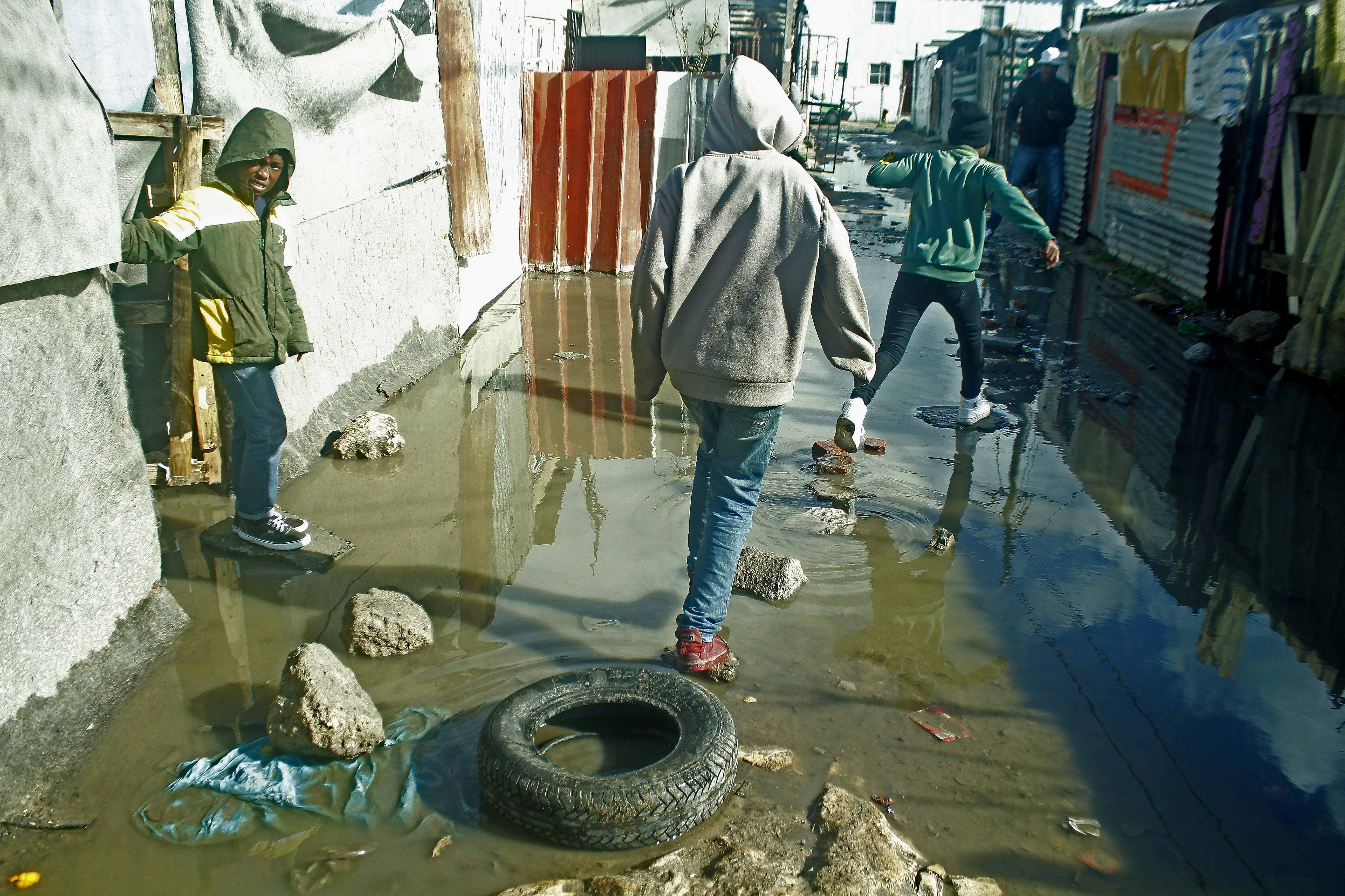 People walking on stones through water