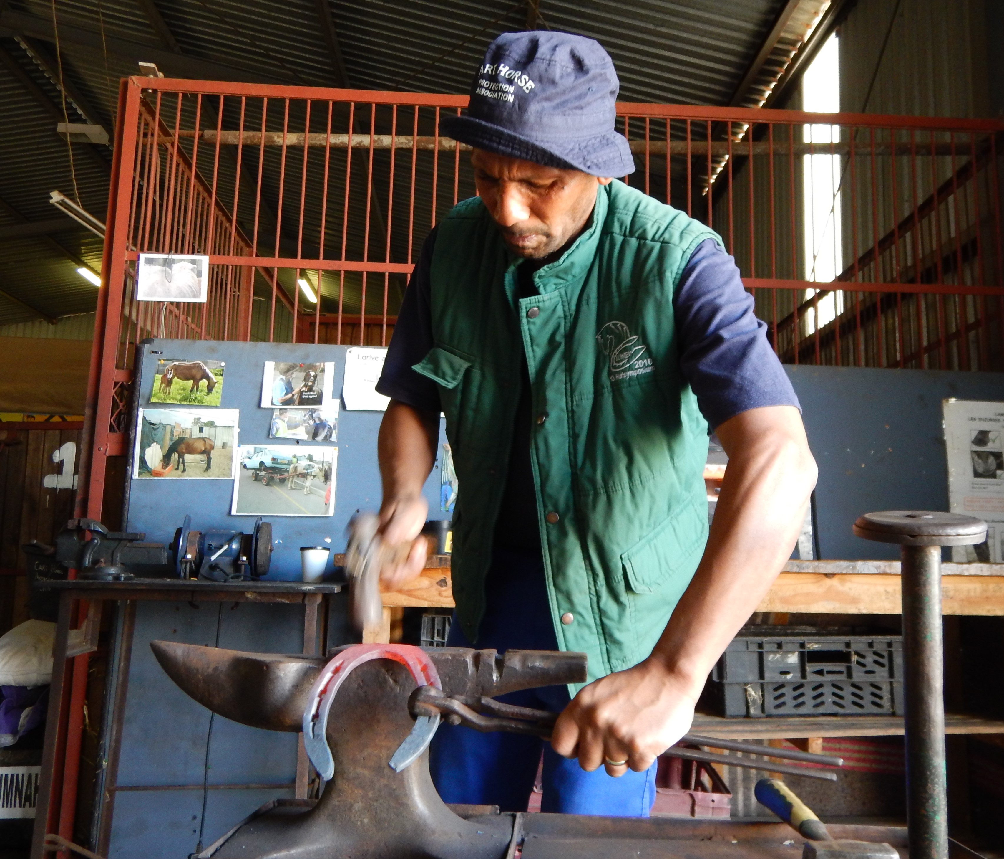 Photo of a smith making a horse shoe