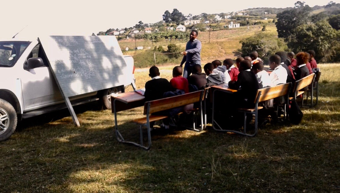 Photo of school children learning outside 