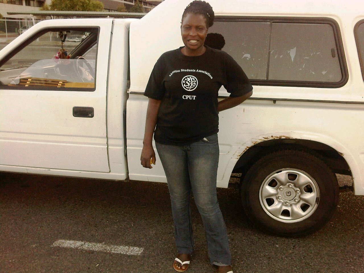 Photo of a woman in front of a car