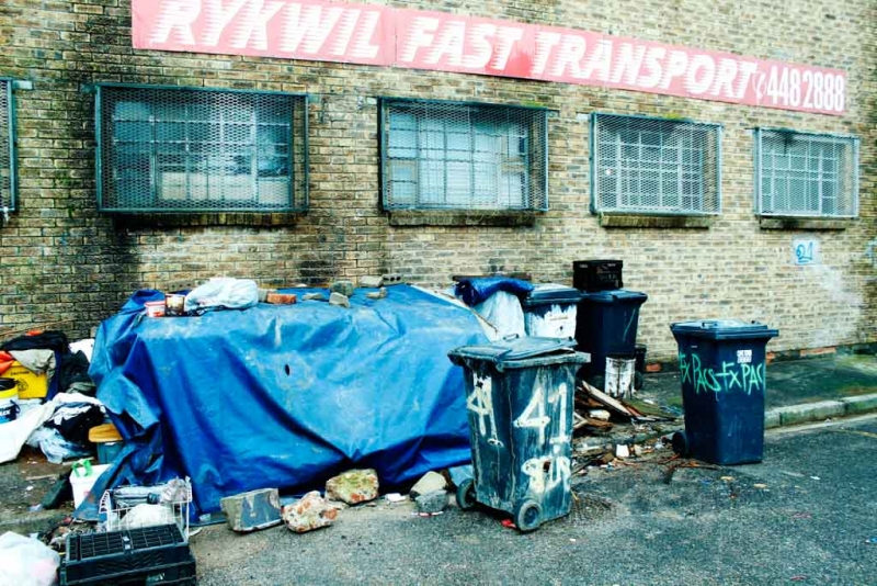 Homeless man living next to a factory building Woodstock 8192.jpg